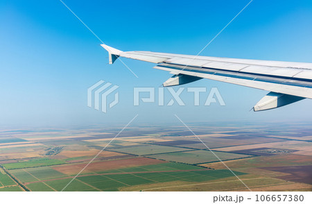 View from the airplane window during taking off on a clear summer morning 106657380