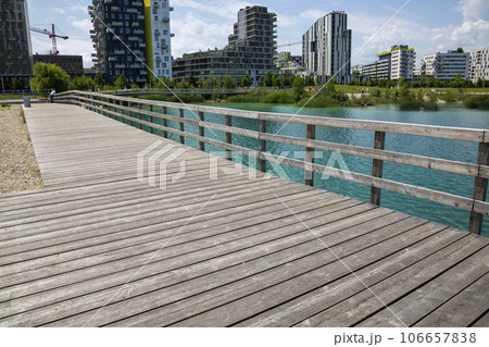 Wooden platform and fence on the shore of Lake Asperner in Vienna Wooden platform and fence on the shore of Lake Asperner in Vienna 106657838