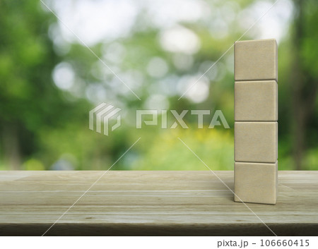 Four wood block cubes on wooden table Four wood block cubes on wooden table 106660415