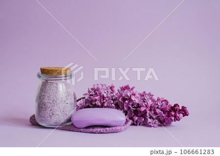 Spa setting with natural soap, sea salt, washcloth glove for body care, lilac flowers on a light background with copy space Spa setting with natural soap, sea salt, washcloth glove for body care, lilac flowers on a light background with copy space 106661283