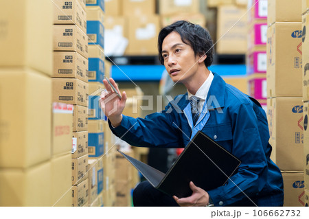 配送センターで働く作業服を着た若い作業員 配送センターで働く作業服を着た若い作業員 106662732