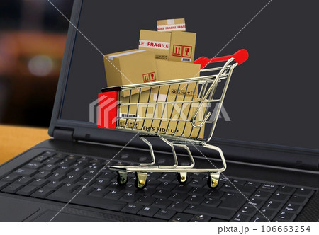 Online shopping and delivery service concept with shopping cart full of boxes on laptop Online shopping and delivery service concept with shopping cart full of boxes on laptop 106663254