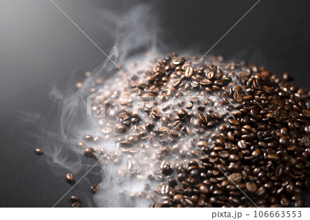Closeup view of fresh roasted coffee beans with smoke 106663553