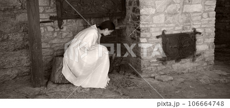 A young girl lights up the stove 106664748