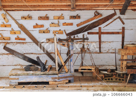 Authentic tools in the house in the rustic style. Installation in museums of traditional rural household items. Authentic tools in the house in the rustic style. Installation in museums of traditional rural household items. 106666043