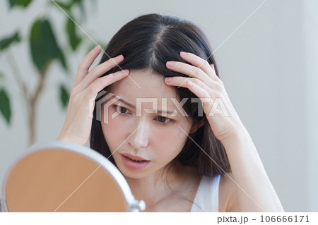髪の生え際をチェックする女性 106666171