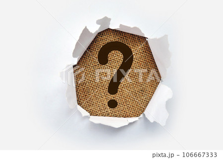 Torn out white paper with question mark symbol. White torn paper revealing question mark symbol on Pink paper. 106667333