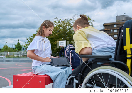 Friendship communication of children of boy in wheelchair and girl 106668115