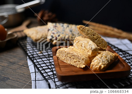 Slices of tempe on the kitchen tabletop. Food from fermented beans or cereals with mold Rhizopus oligosporus 106668334