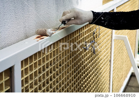 錆びた鉄製門扉を塗装する職人　塗装工事　03 106668910