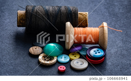 Sewing buttons and thread spool 106668941