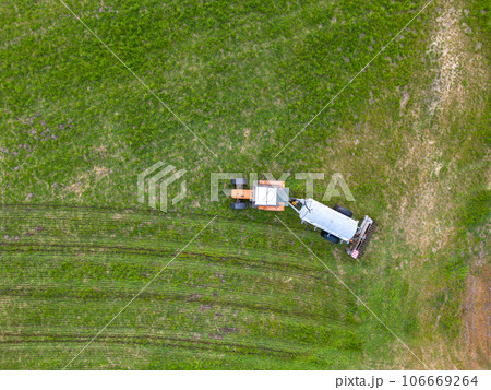 aerial view of tractor , combine cultivating field. drone shot. picture with space for text aerial view of tractor , combine cultivating field. drone shot. picture with space for text 106669264