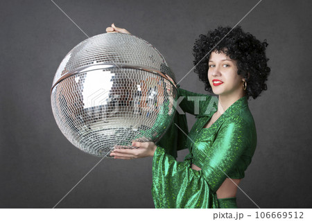 Happy girls in disco style, with disco ball, halloween party, on gray background. 80s themed party. 106669512
