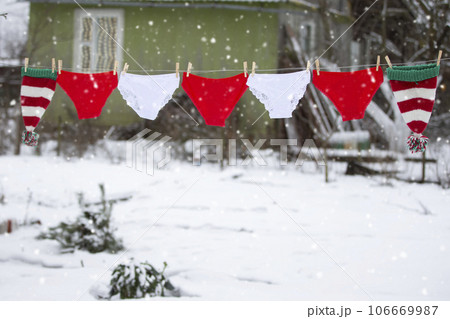 Red and white shorts are hung in the form of a Christmas garland. Red and white shorts are hung in the form of a Christmas garland. 106669987