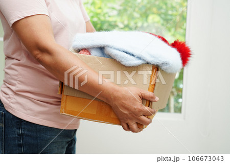 Clothes donations in cardboard box for volunteer. Clothes donations in cardboard box for volunteer. 106673043