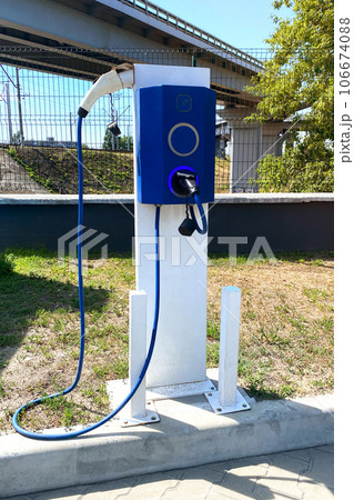 Eco friendly transport concept. Electric charging station in city. Vertical view. Eco friendly transport concept. Electric charging station in city. Vertical view. 106674088