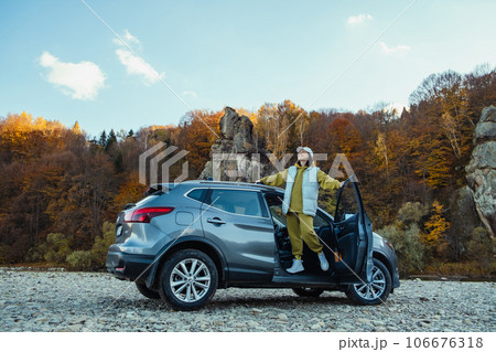 happy woman car traveler at rocky river beach 106676318