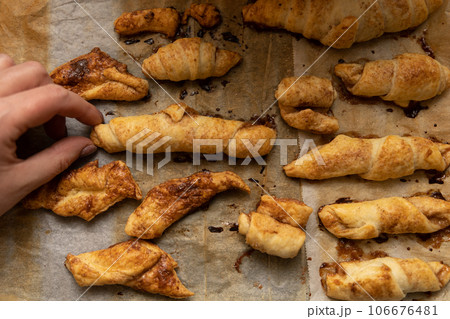 home made pastry in hand and on a baking tray 106676481