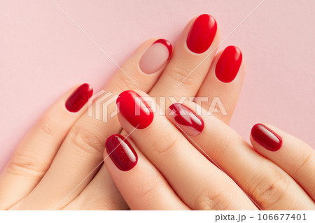 Womans hands with trendy red shiny manicure. Beauty treatment spa body care concept 106677401