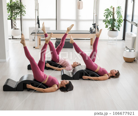 Balanced Body Pilates Arc. Three asian women exercising on pilates arc.  106677921