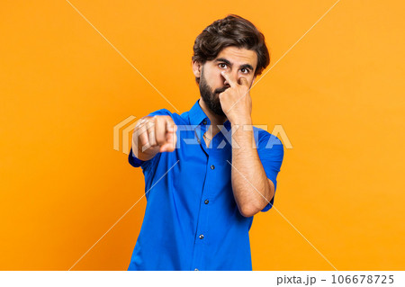 Man pointing at her eyes and camera show I am watching you gesture spying watching on someone 106678725