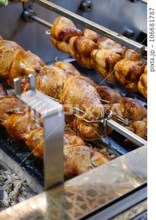 Roasted chickens grilled on the fire of the barbecue Roasted chickens grilled on the fire of the barbecue 106681787