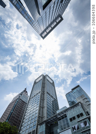 Low angle view of the plaza in Xinyi Business District, Taipei, Taiwan. the District is Taipei's main shopping area, anchored by various department stores and malls. Low angle view of the plaza in Xinyi Business District, Taipei, Taiwan. the District is Taipei's main shopping area, anchored by various department stores and malls. 106684398