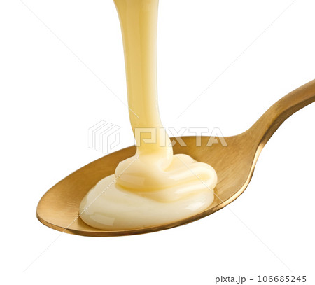 condensed milk in golden spoon 106685245