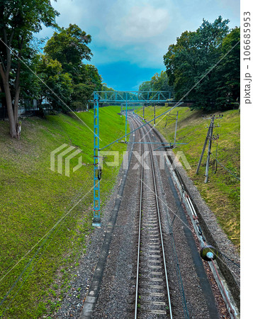 Railway with green vegetation on the sides. View from the bridge . High quality photo Railway with green vegetation on the sides. View from the bridge . High quality photo 106685953
