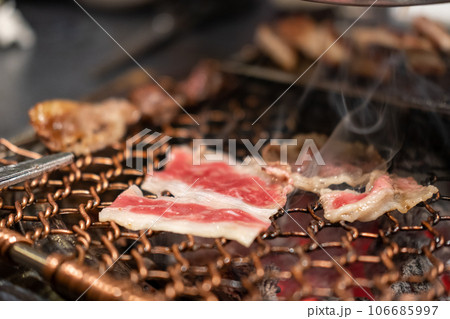 Korean Style Barbecue on stainless grill. BBQ rare meat with soft focus 106685997