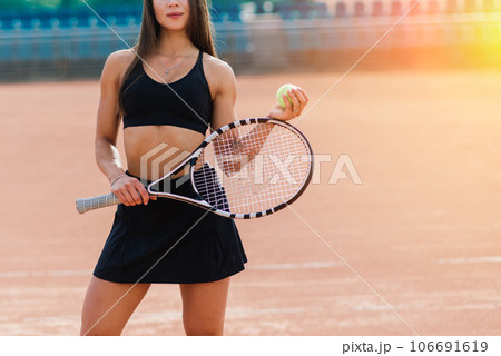Beautiful stylish sexy woman in black trendy sportswear on tennis court. 106691619