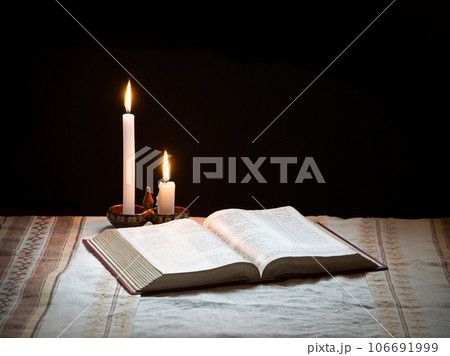 Still life from ancient book with candle 106691999
