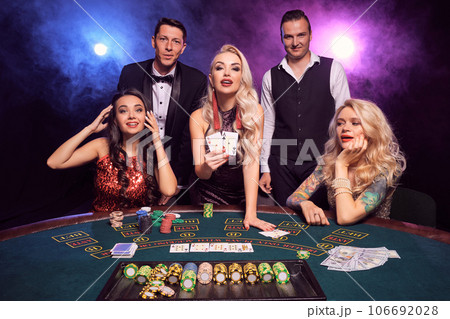 Group of a young wealthy friends are playing poker at a casino. 106692028