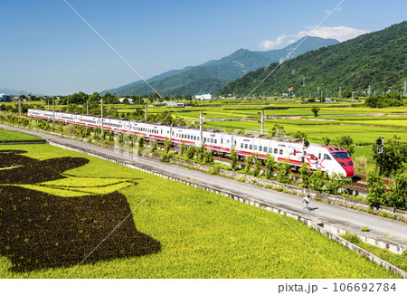 Tze-Chiang Limited Express(Puyuma) trains are passing through the beautiful landscape of rice paddy fields in Hualien, Taiwan. Tze-Chiang Limited Express(Puyuma) trains are passing through the beautiful landscape of rice paddy fields in Hualien, Taiwan. 106692784