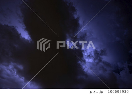 Ray. Storm. The sky is full of dark clouds in bad weather before a big storm rain. Light emission from the Edge of clouds. Zoom the surface of a Black haze at close range. 106692936