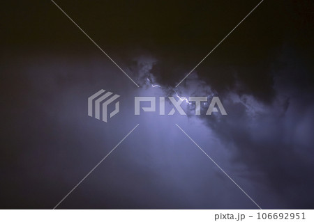 Ray. Storm. The sky is full of dark clouds in bad weather before a big storm rain. Light emission from the Edge of clouds. Zoom the surface of a Black haze at close range. Ray. Storm. The sky is full of dark clouds in bad weather before a big storm rain. Light emission from the Edge of clouds. Zoom the surface of a Black haze at close range. 106692951