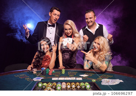 Group of a young wealthy friends are playing poker at a casino. Group of a young wealthy friends are playing poker at a casino. 106696297