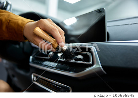 Closeup dashboard washing, car detailing and dry cleaning service Closeup dashboard washing, car detailing and dry cleaning service 106696948