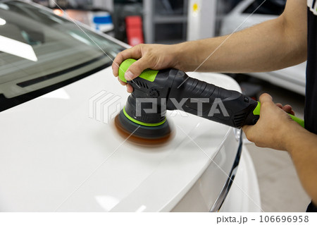 Professional worker applying special polishing paste and tool for car refreshment Professional worker applying special polishing paste and tool for car refreshment 106696958