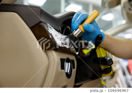 Car detailing, procedure, closeup master washing dashboard with soft brush Car detailing, procedure, closeup master washing dashboard with soft brush 106696967