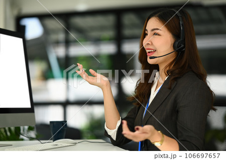 Positive representative call center woman in conversation with customer over headset Positive representative call center woman in conversation with customer over headset 106697657