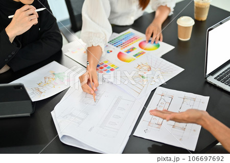 Interior designer team brainstorming and planning construction project together at co working space 106697692
