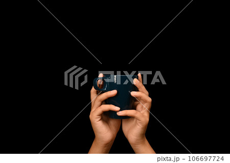 Woman hands holding coffee cup over black background. Close up, mockup image, copy space for text Woman hands holding coffee cup over black background. Close up, mockup image, copy space for text 106697724