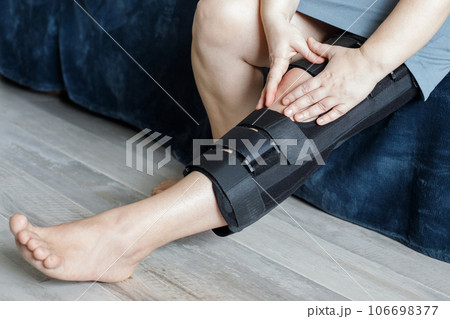 Rehabilitation for knee injury. Knee braces on woman 's leg Rehabilitation for knee injury. Knee braces on woman 's leg 106698377