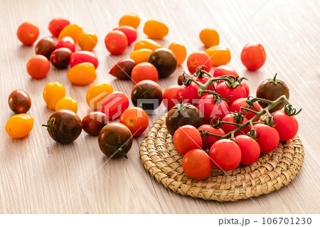 Small red cherry tomatoes on rustic background 106701230
