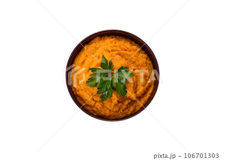 Squash caviar with garlic and tomatoes in a rustic bowl on a dark background Squash caviar with garlic and tomatoes in a rustic bowl on a dark background 106701303