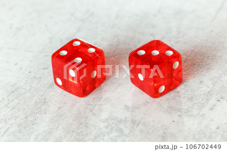 Two translucent red craps dices on white board showing Natural or Seven Out (number 4 and 3) 106702449