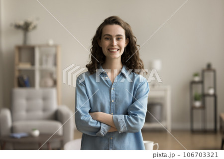 Cheerful confident gen Z young adult girl home head shot Cheerful confident gen Z young adult girl home head shot 106703321