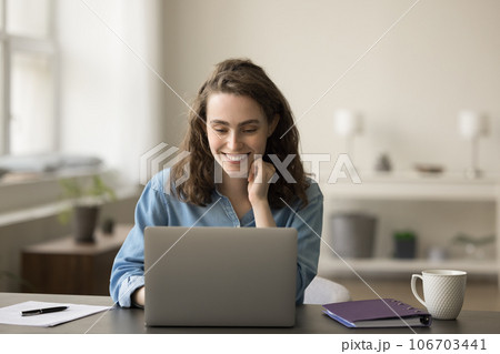 Positive young freelancer girl working at laptop, typing Positive young freelancer girl working at laptop, typing 106703441