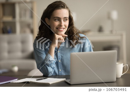 Cheerful dreamy freelance professional woman thinking on creative idea 106703491
